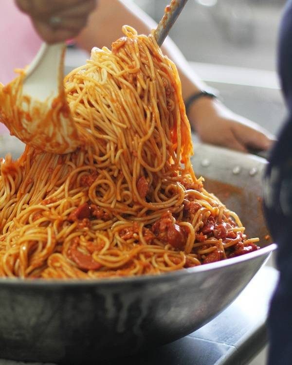Tossing together filipino spaghetti.