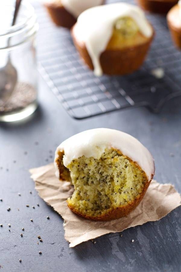 Lemon muffins with glaze on a piece of paper.