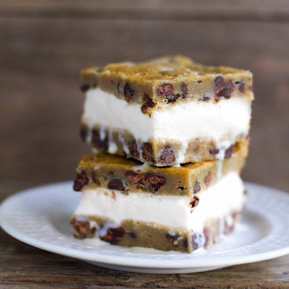 Chocolate chip cookie ice cream bars stacked on each other on a plate.